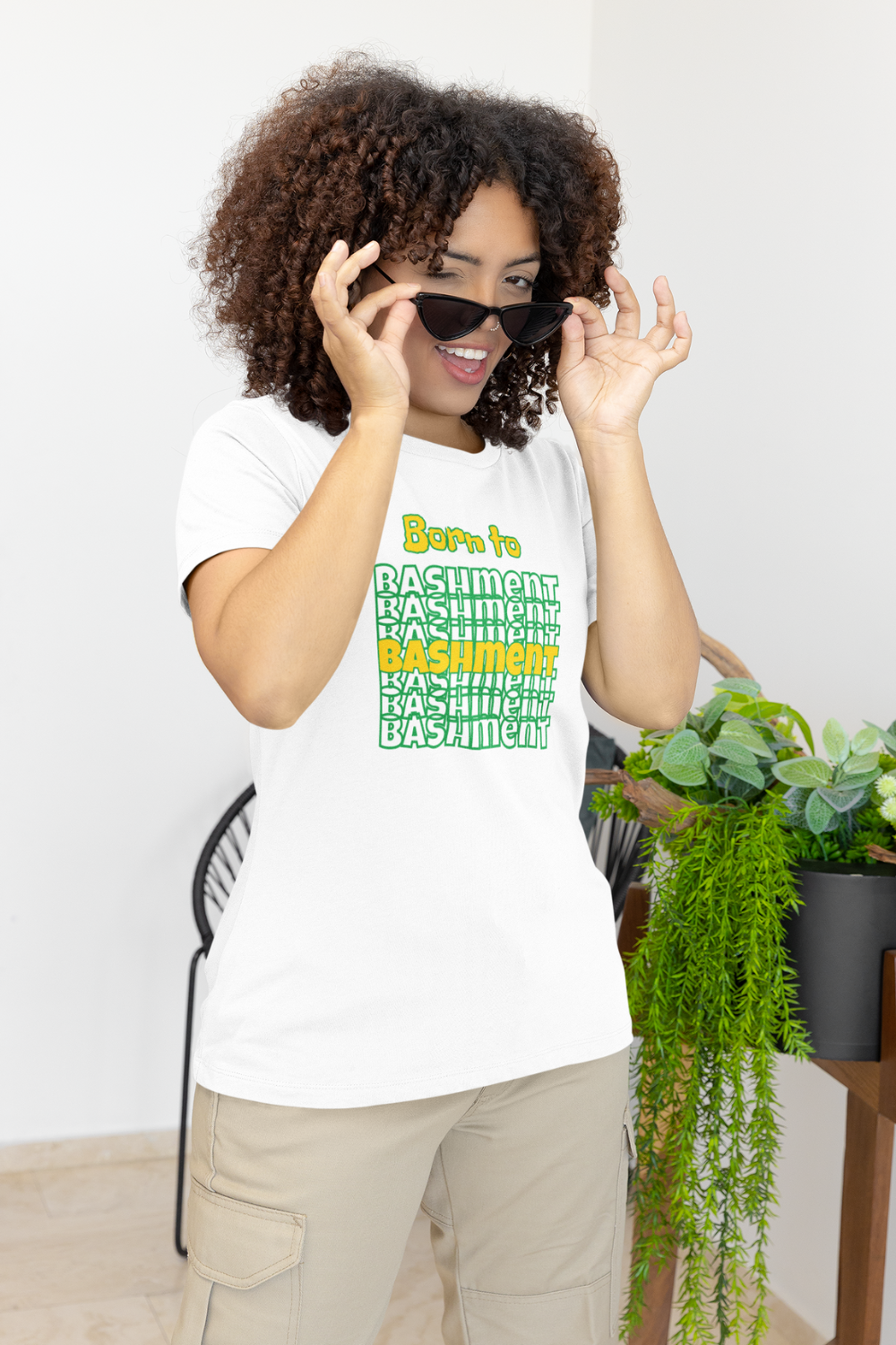 Female model wearing Born to Bashment Caribbean carnival Tee in white, premium unisex cotton t-shirt celebrating Caribbean culture, festivals