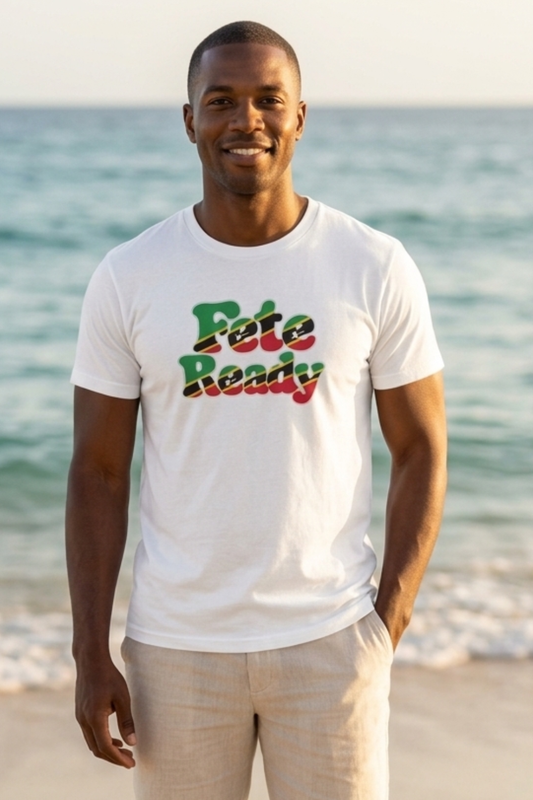 A man standing on a beach wearing a white t-shirt with 'St Kitts and Nevis flag colors green, red, black and yellow, paired with beige pants. Culture you wear everyday.
