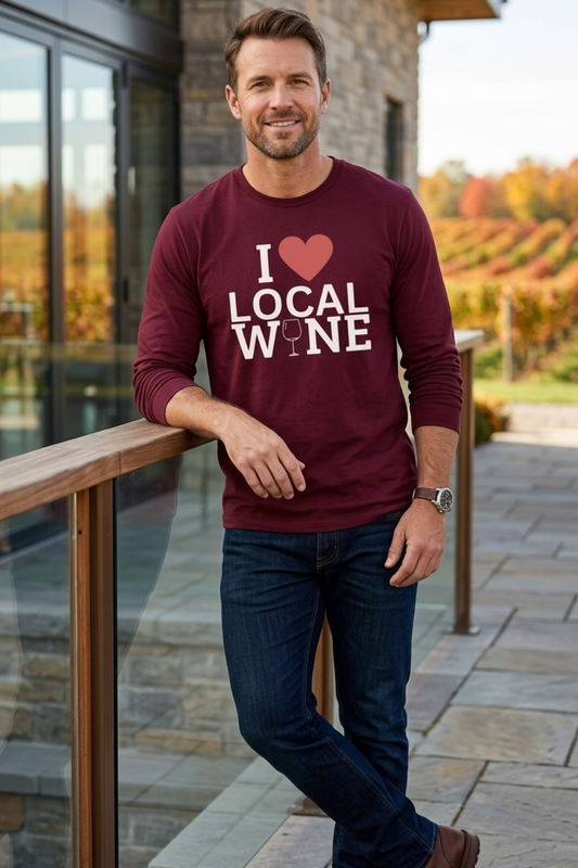 Man wearing a burgundy I Love Local Wine long-sleeve t-shirt with heart and wine glass design, styled with dark jeans in autumn.