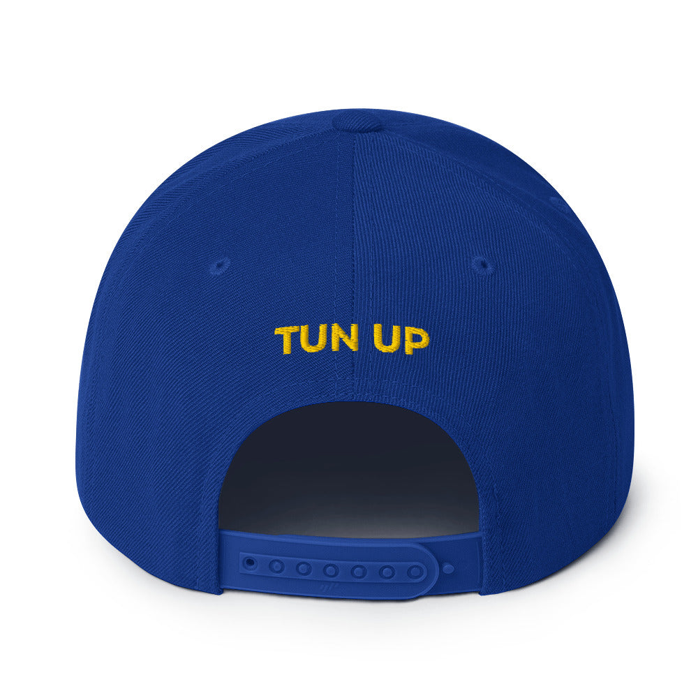 Back of royal blue snapback hat showing yellow “Tun Up” embroidery above the closure — bold Caribbean expression for high-energy island vibes.